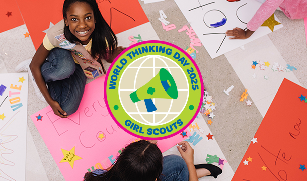 group of young girl scout daisies hiking with adult volunteer